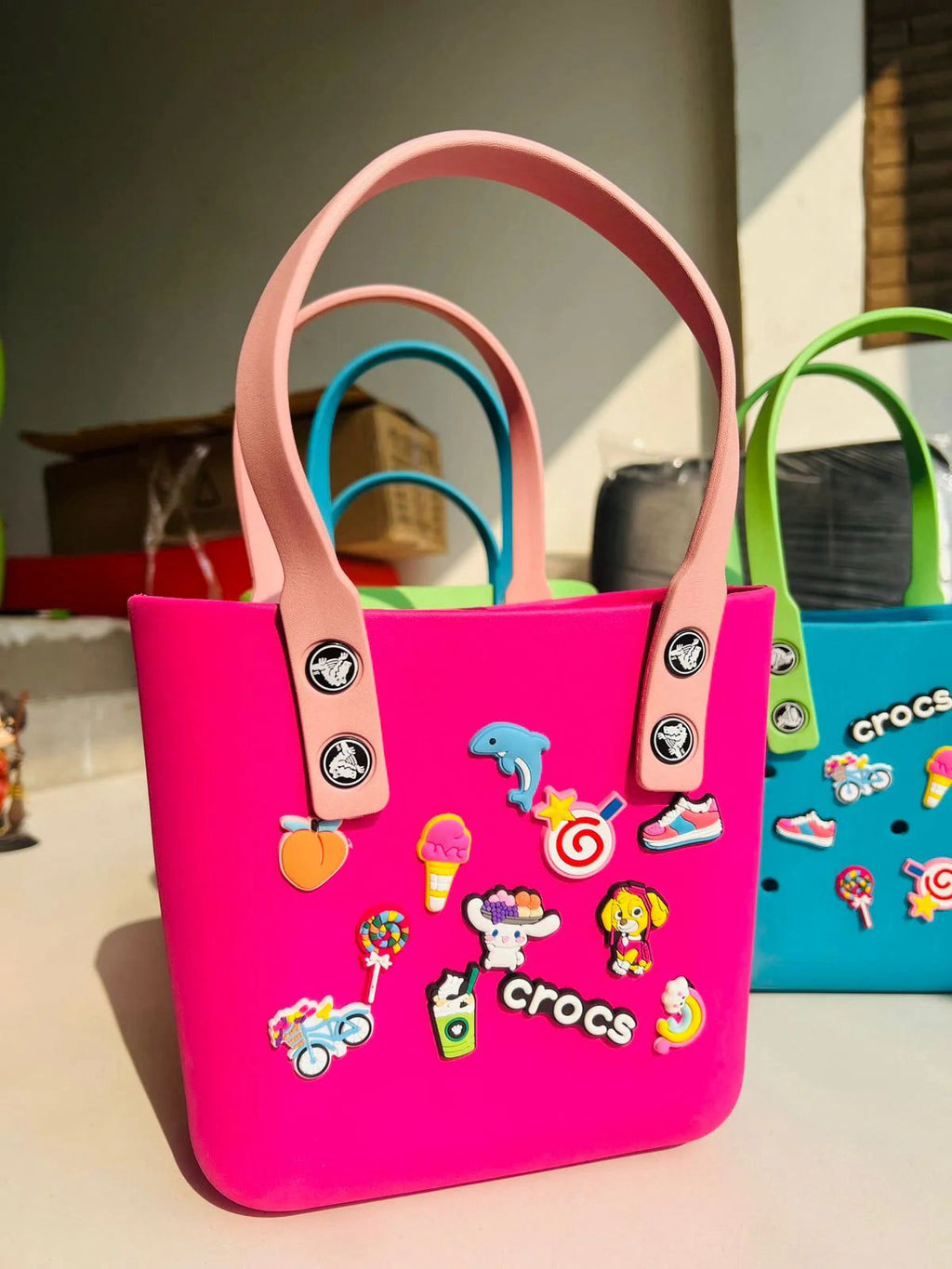 Crocs Classic Tote waterproof bags with Jibbitz charms attached